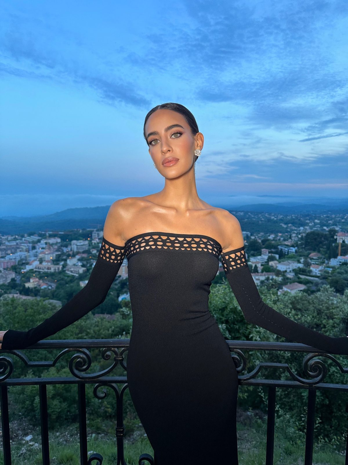 Off-shoulder black gown at dusk over Cannes, hair and makeup by Andrada Rusu